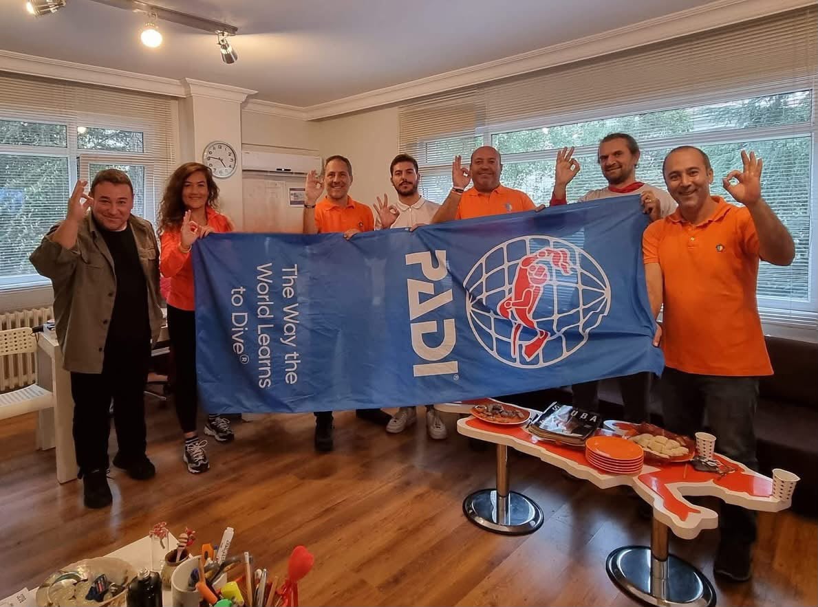 Deepist team at the Istanbul office with a PADI flag